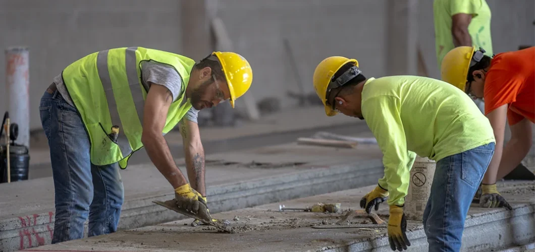 Two concrete construction workers in the manufacturing process at Boccella Precast, a leading precast concrete manufacturer in the Northeastern US.